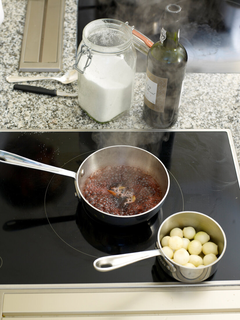 Ingredients being boiled for pickled pearl onions in pan