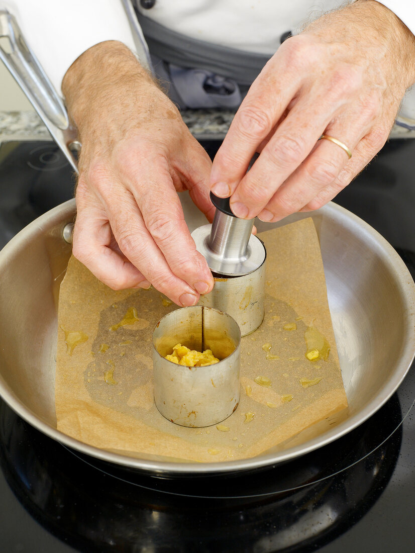 Putting pieces of corn in cookie cutter