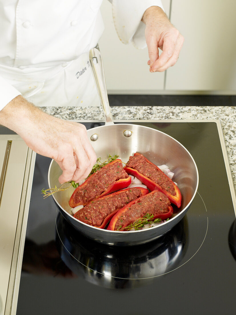 Cooking stuffed bell peppers in pan