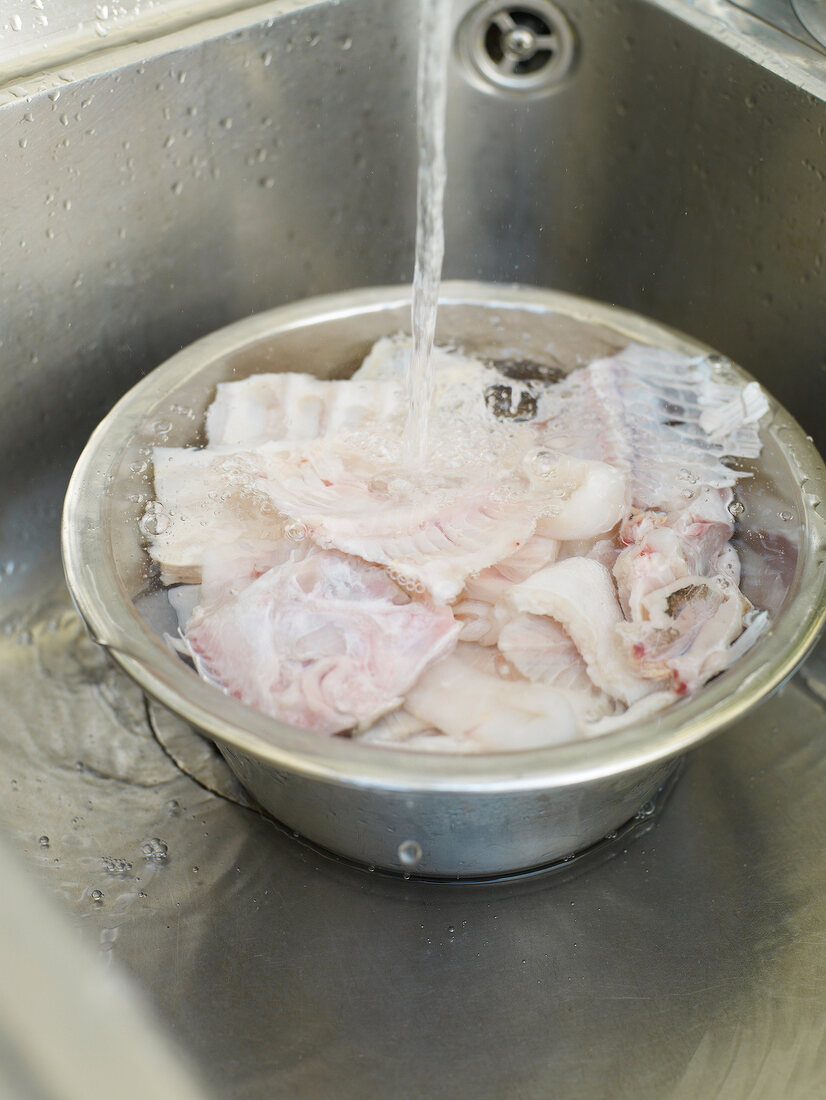 Fish being washed in sink