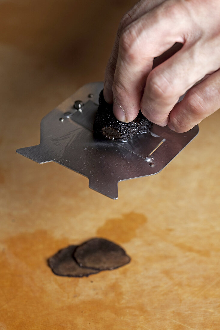 Close-up of slicing truffle into thin slices