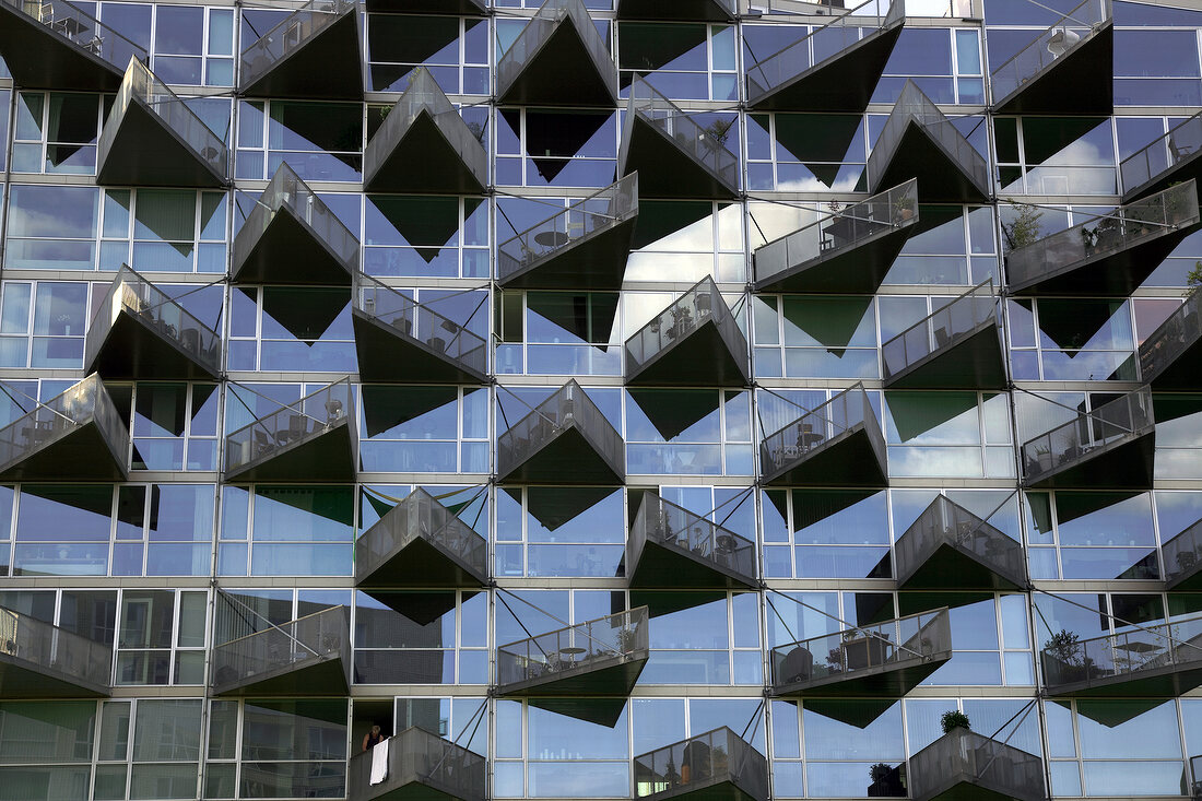 Glass facade of VM-house with triangular balconies in Copenhagen, Denmark