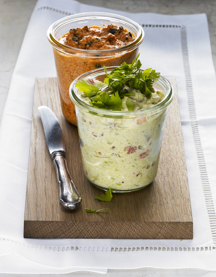 Garnished vegetable and herb spreads in glass