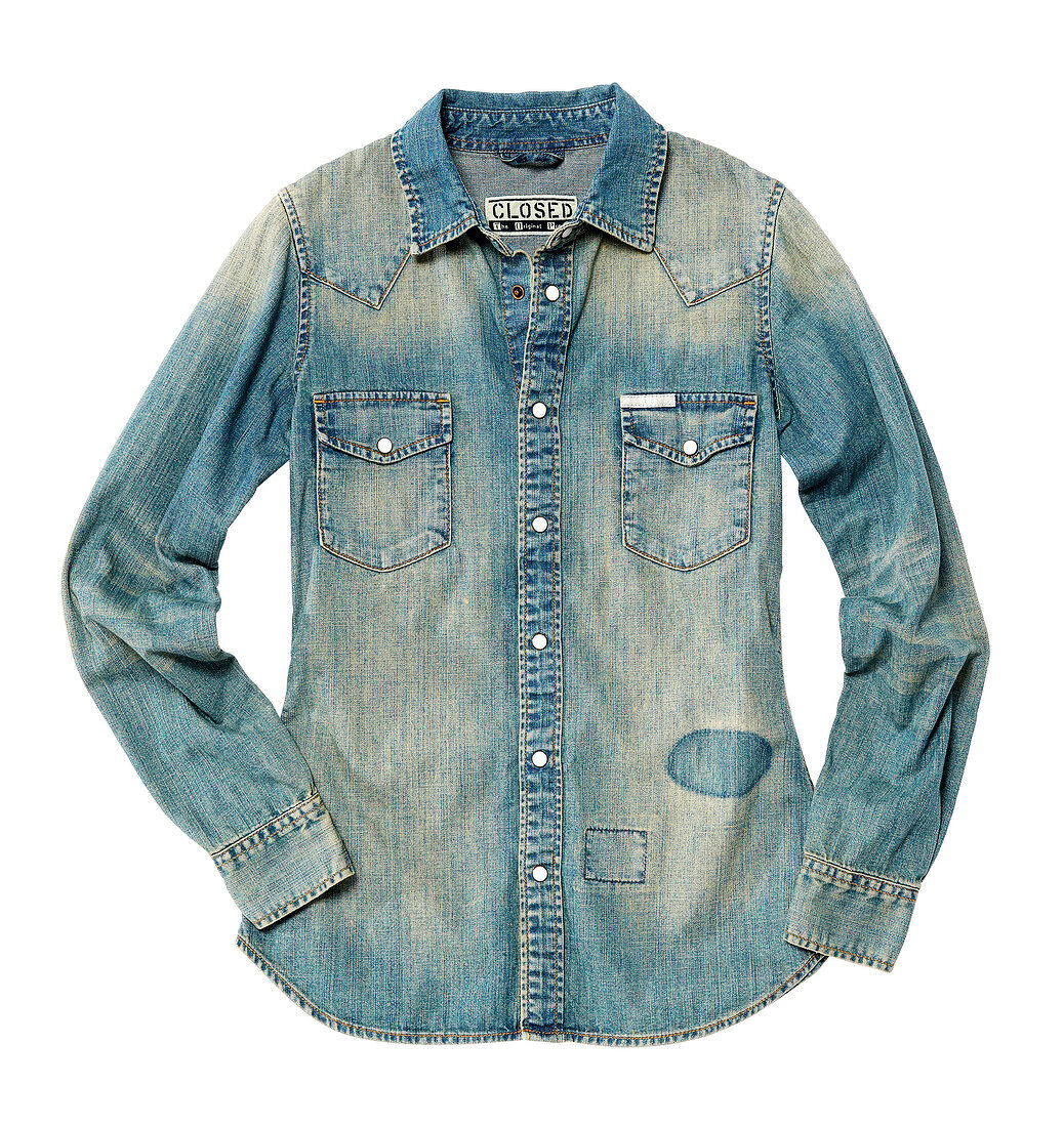 Close-up of oversized ladies denim shirt on white background