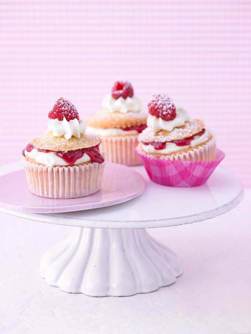 Raspberry mascarpone cupcakes on a cake stand