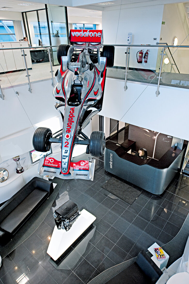Discarded race car on ceiling above lobby, elevated view