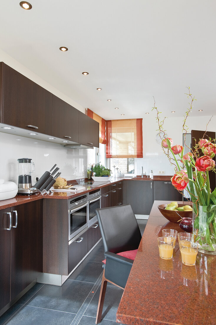 View of kitchen with brown cabinets and dining area