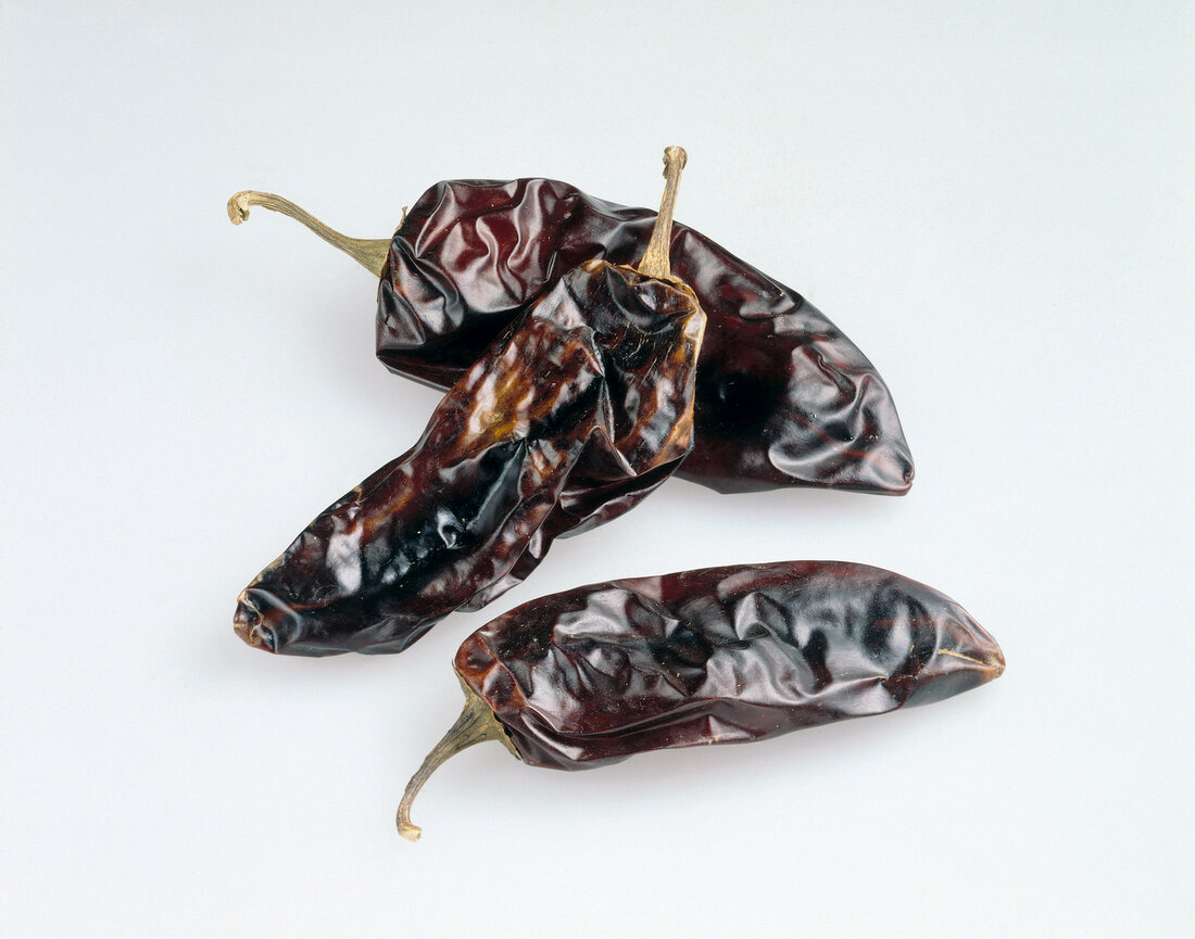 Dried chillies on white background, California, USA