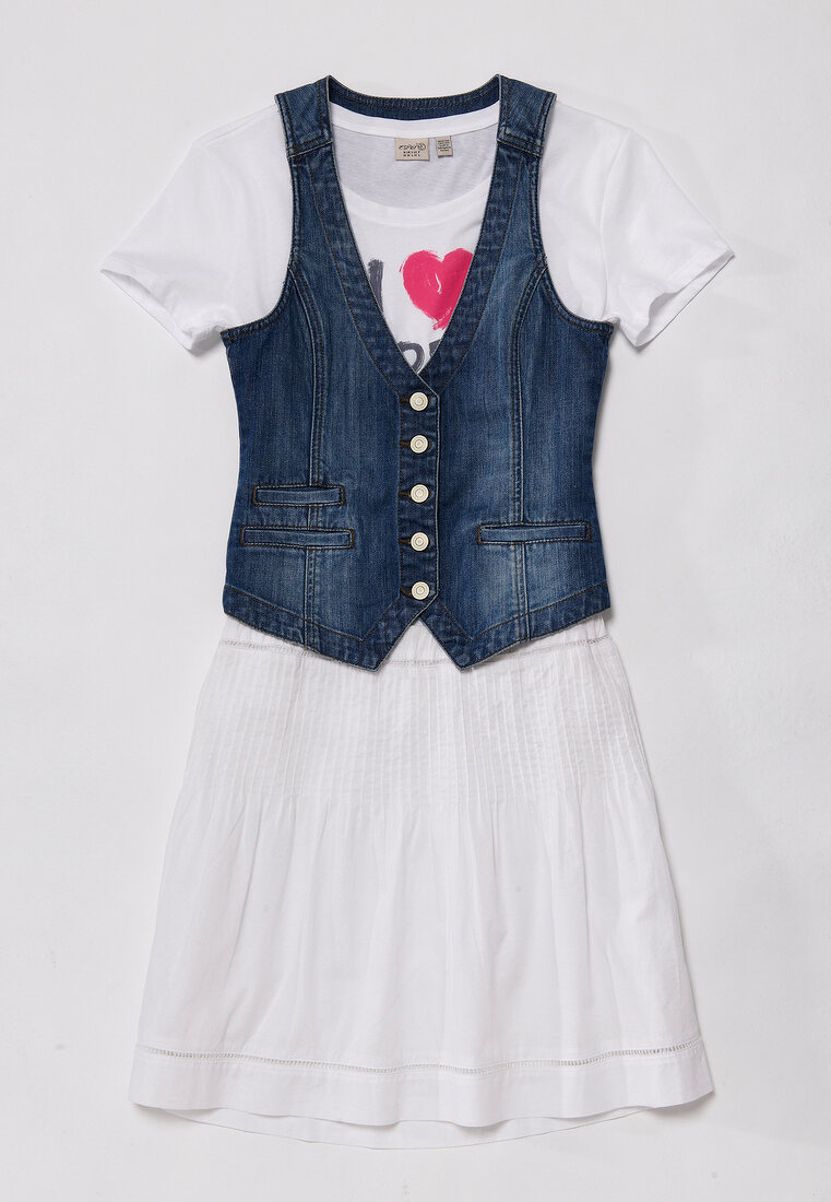 Denim vest with white skirt and top on white background