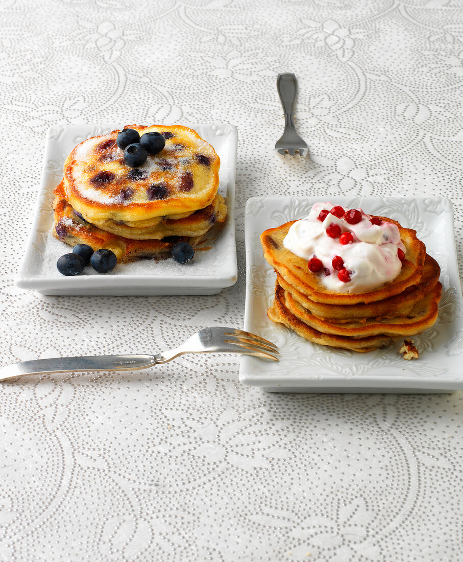 Plates of blueberry buttermilk pancakes and Christmas pancakes