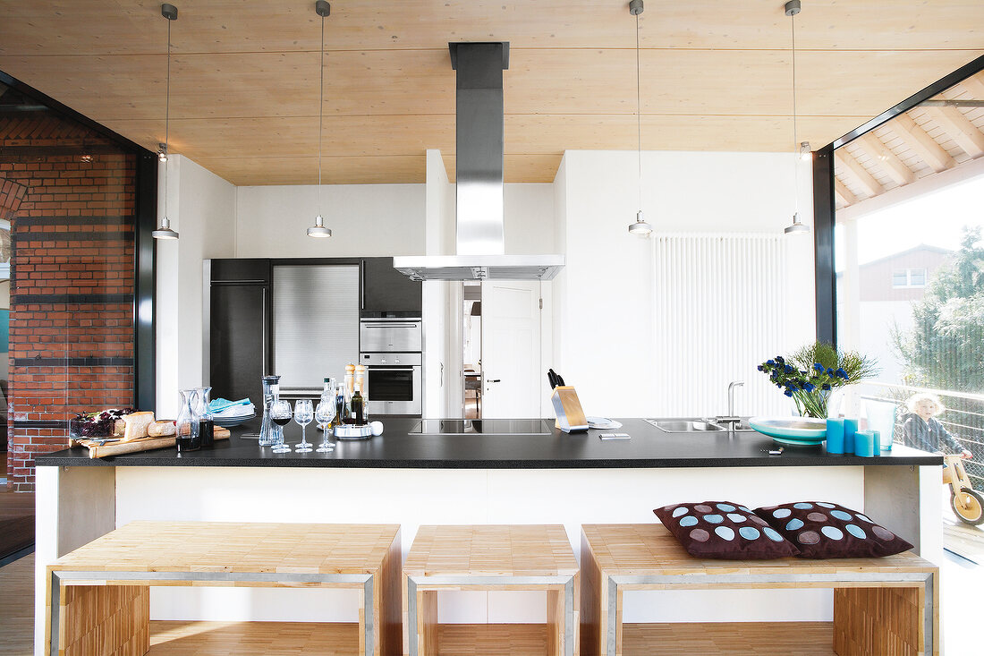 Wooden stools in front of kitchen countertop