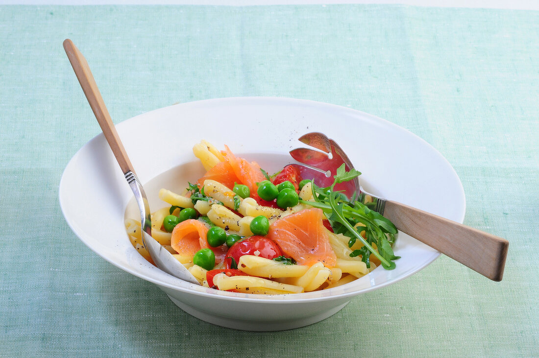 Pasta salad with salmon fillet in bowl