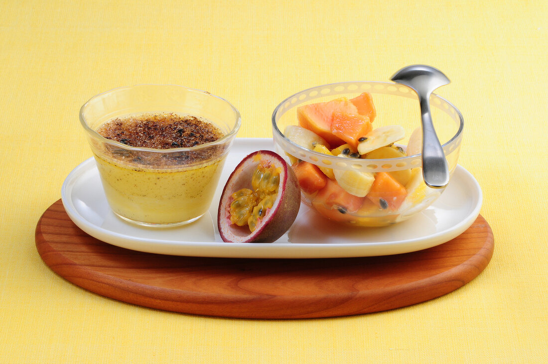 Fruit salad with passion fruit cream in bowls