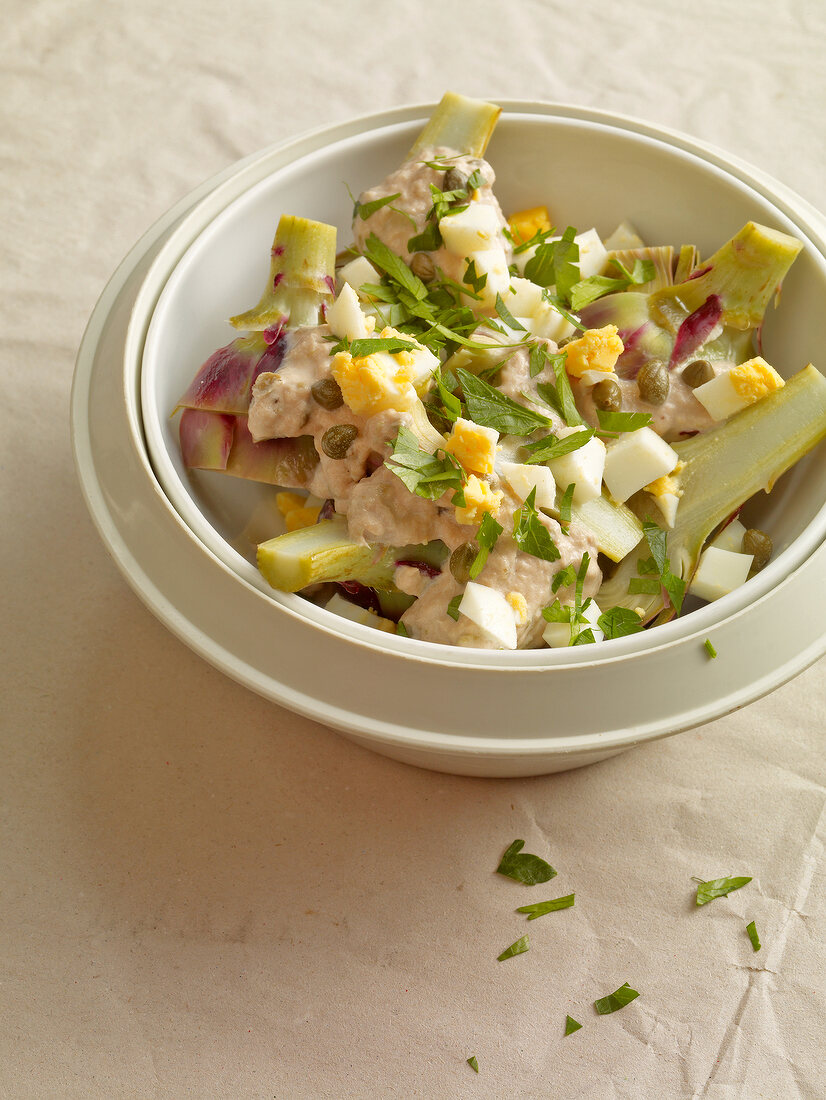 Close-up of artichoke salad with tuna sauce in bowl