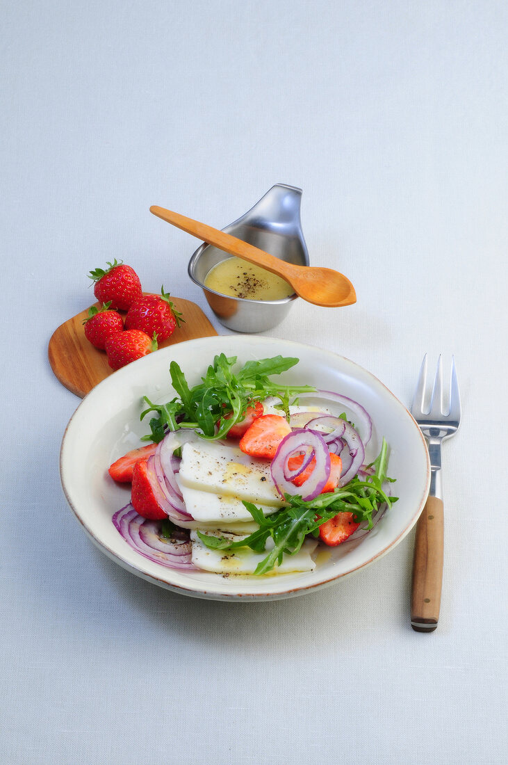 Arugula and strawberry salad in bowl