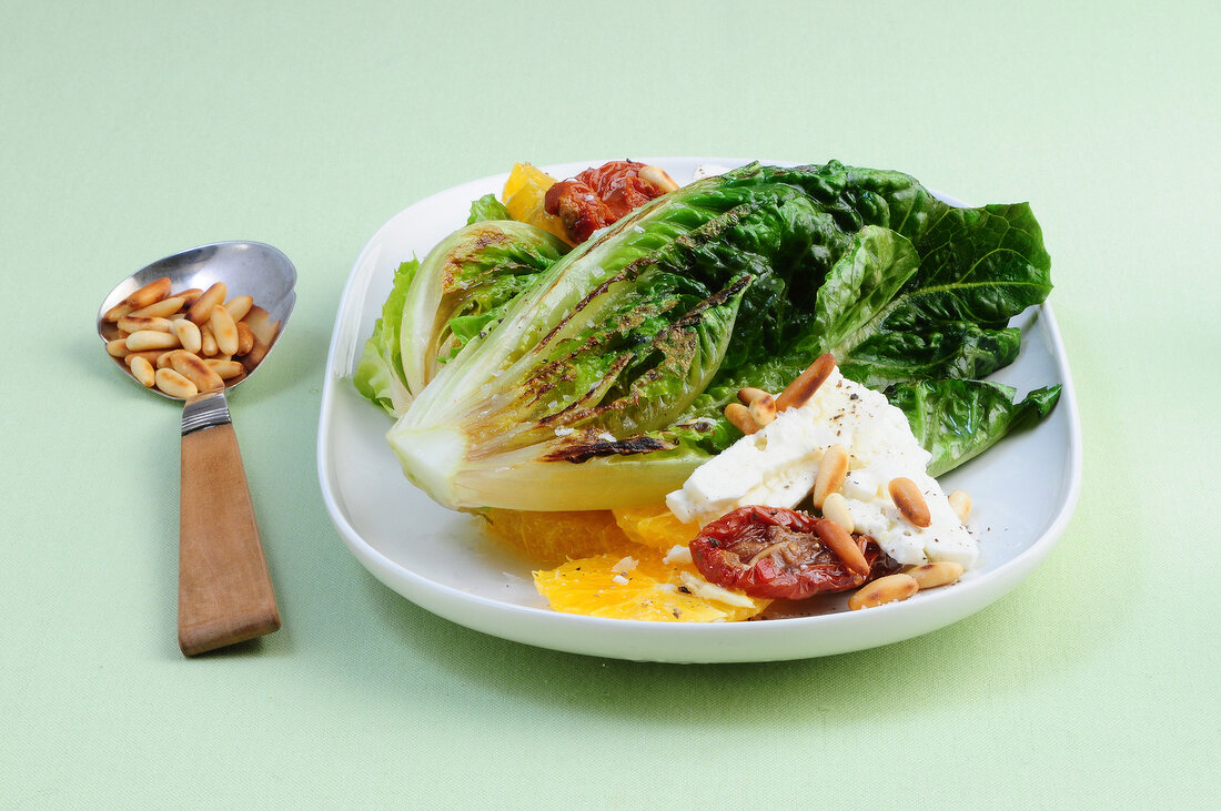 Salad made of lettuce, orange and feta on plate