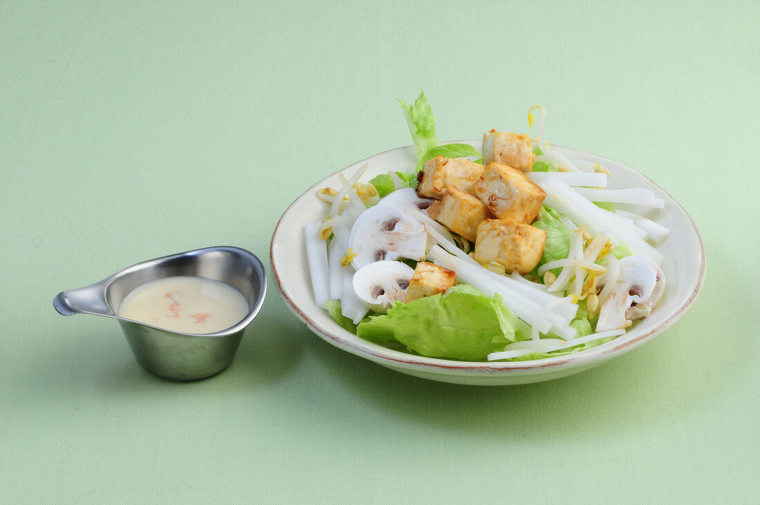 Iceberg lettuce with sprouts and tofu on plate