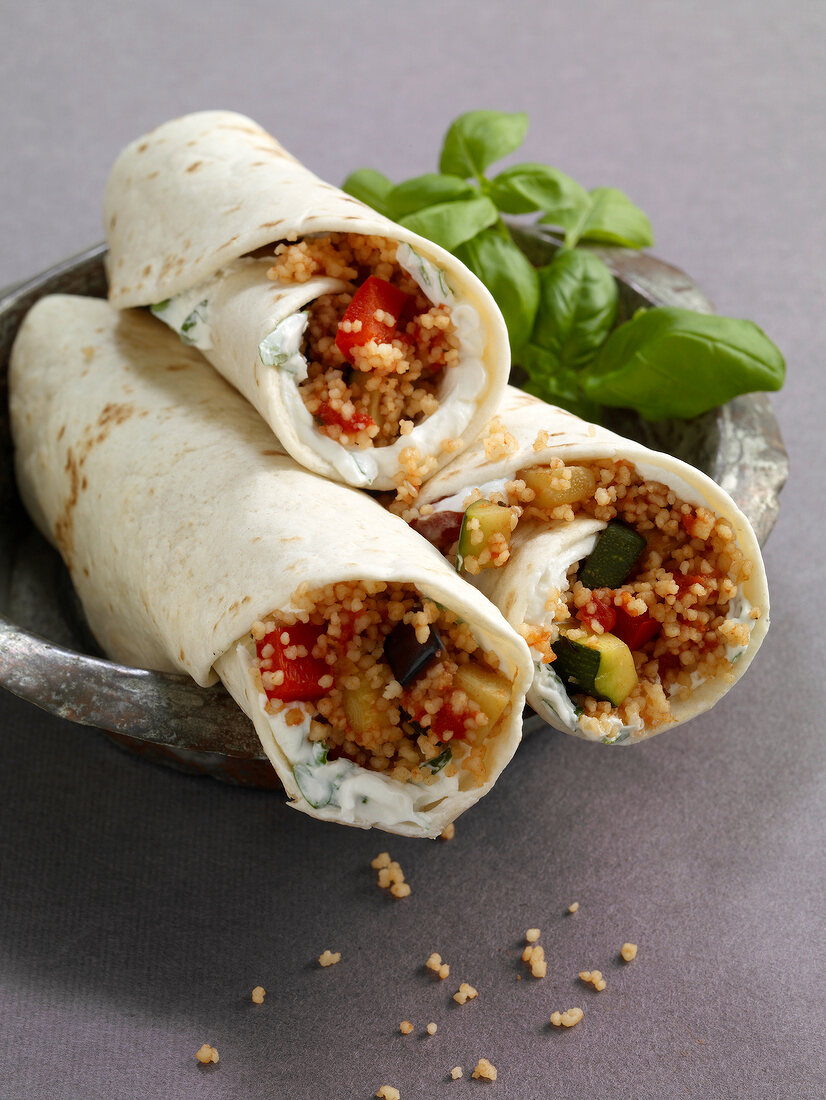 Close-up of wraps with couscous and ratatouille in bowl