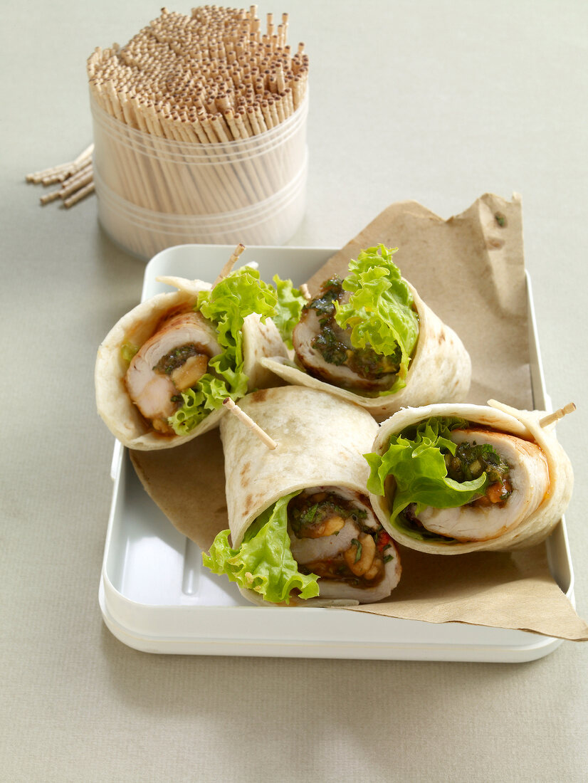 Close-up of wraps with turkey steaks on tray