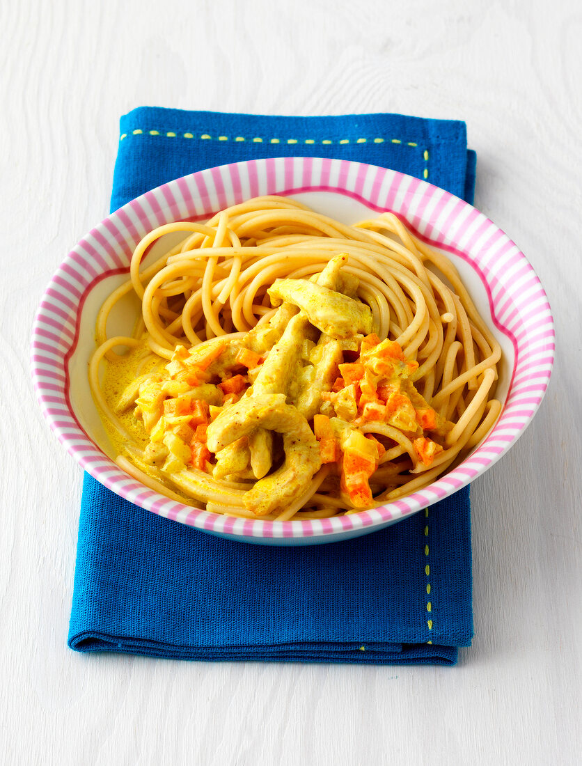Spaghetti with turkey and carrots in bowl