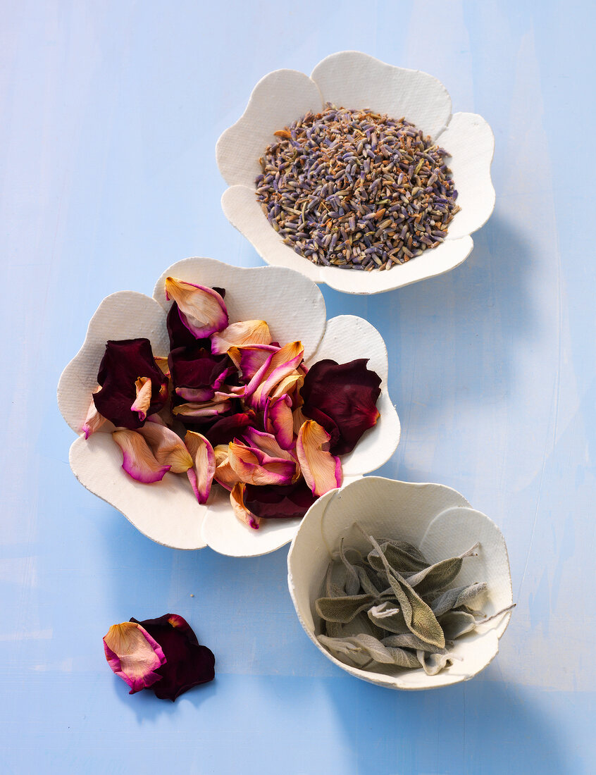 Three bowls of dried flowers and herbs