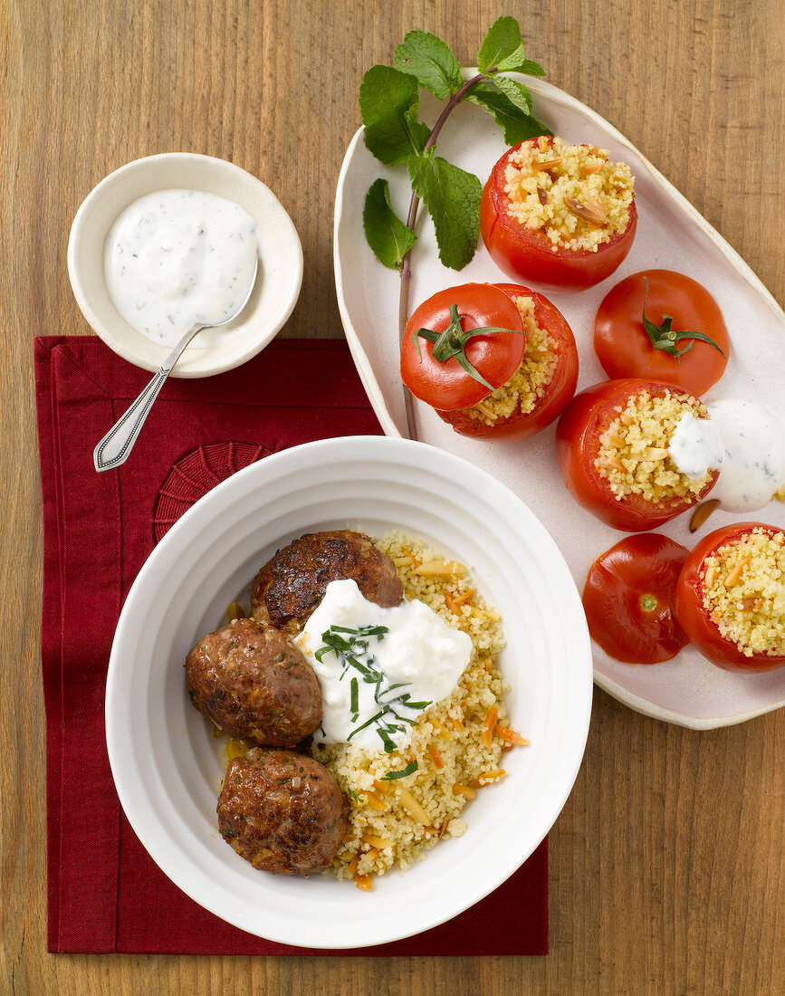 Meatballs with couscous and tomatoes stuffed with couscous on plate