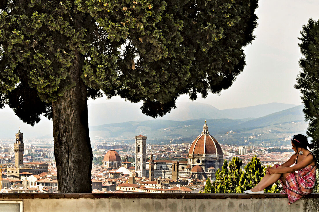 View of woman looking at Florence city from Monte alle Croci, Florence, Italy