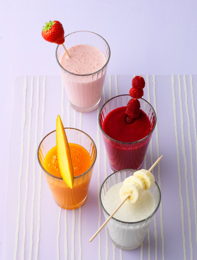 Smoothies with fruits in glasses