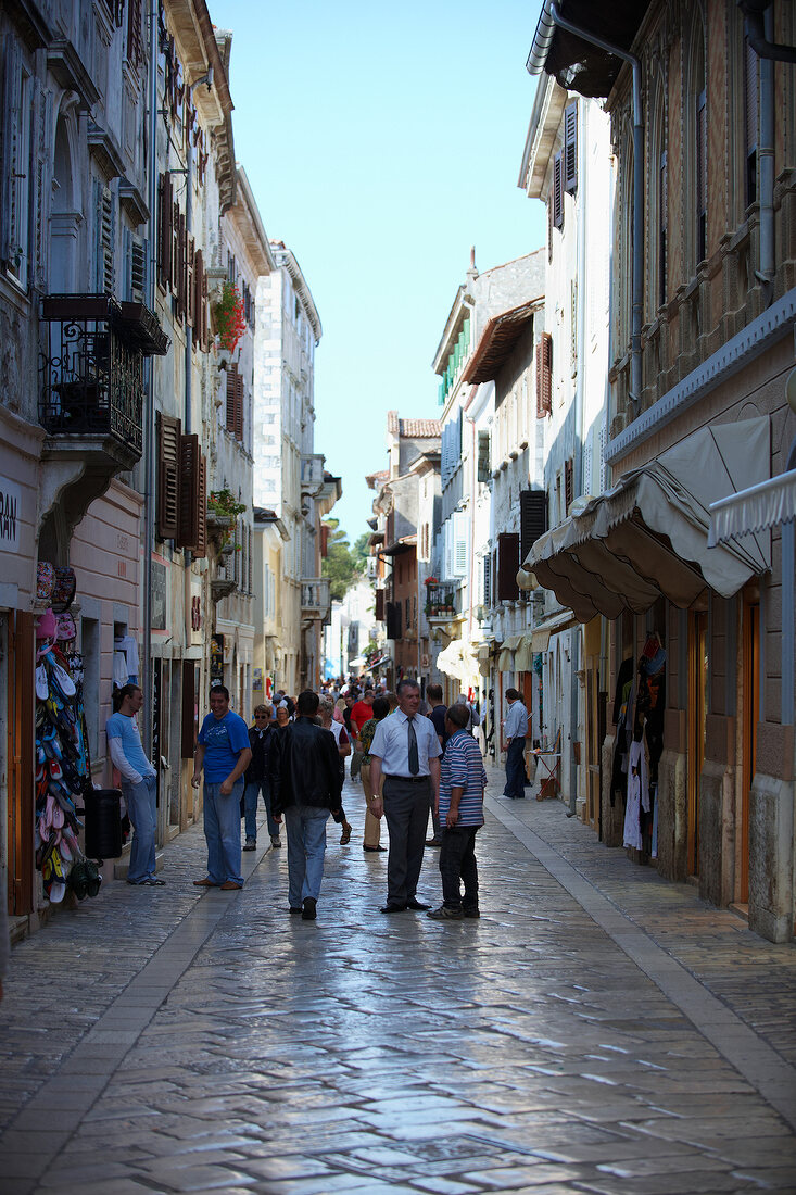 People standing in alley at the old town of Porec, Istria, Croatia