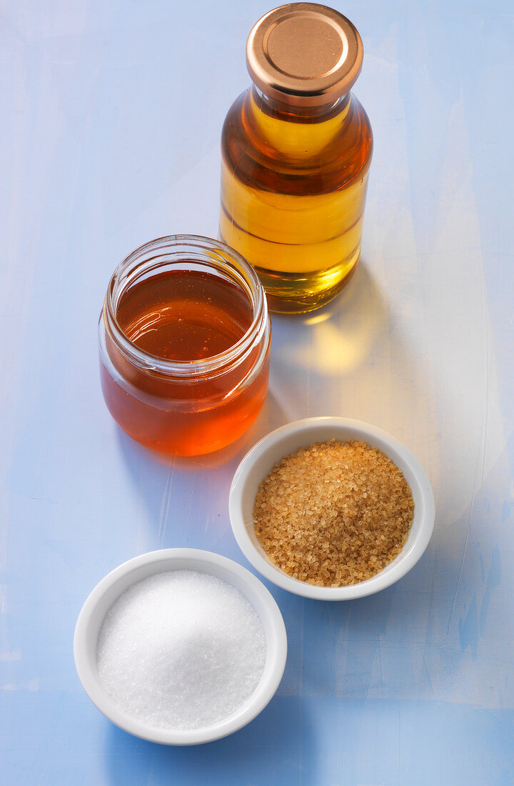 Various sweeteners in jar, bottle and bowls