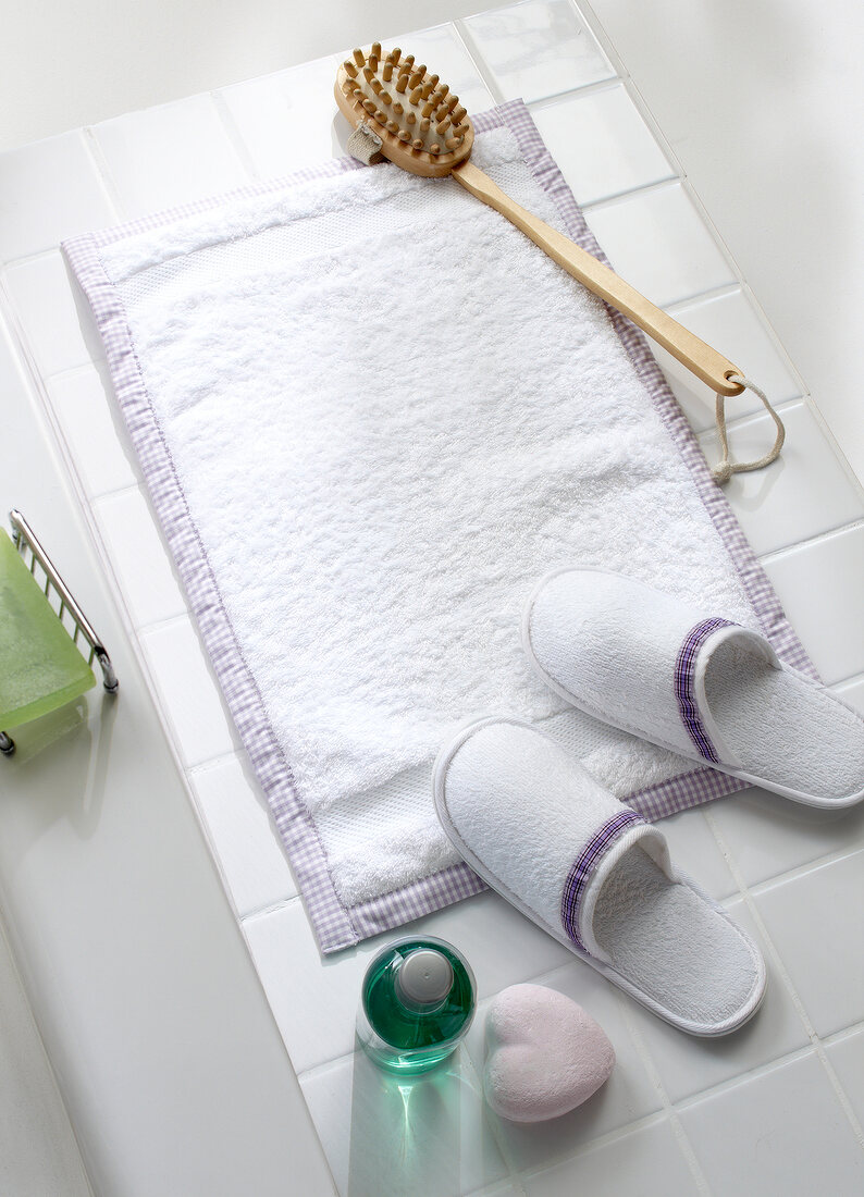 Terry cloth towel with fleece, bathroom slippers, brush and other bathroom accessories