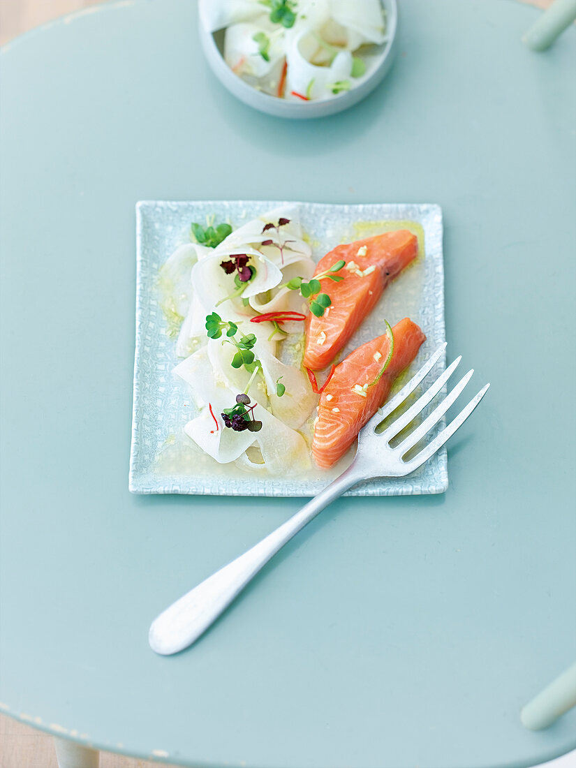 Salmon with radish salad on plate