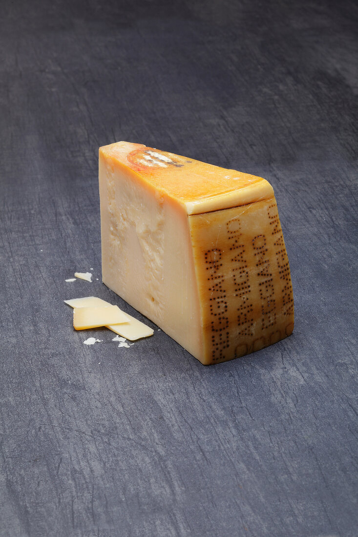 Parmigiano reggiano cheese on gray surface