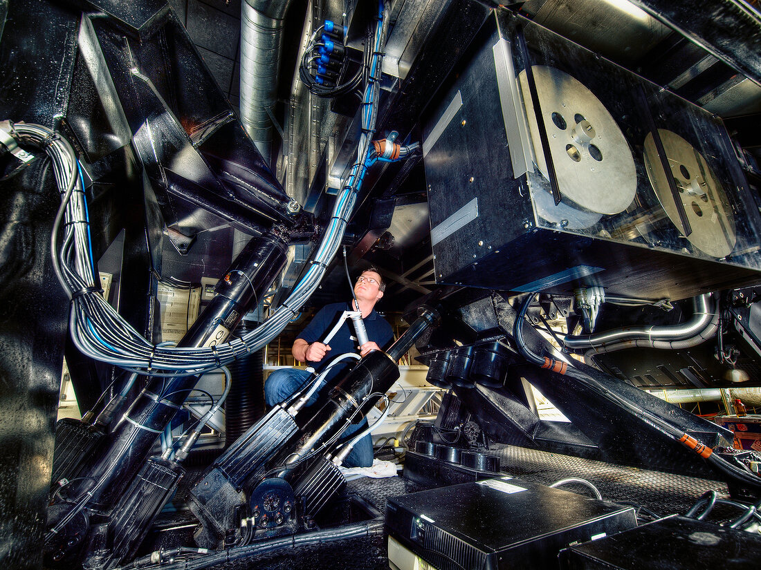 Person with technical instrument in hydraulic simulator, Autostadt, Wolfsburg, Germany