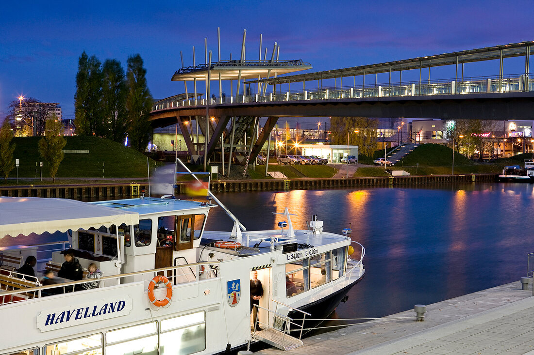Ship at Mittelland canal and bridge over it at night, Autostadt Wolfsburg, Germany