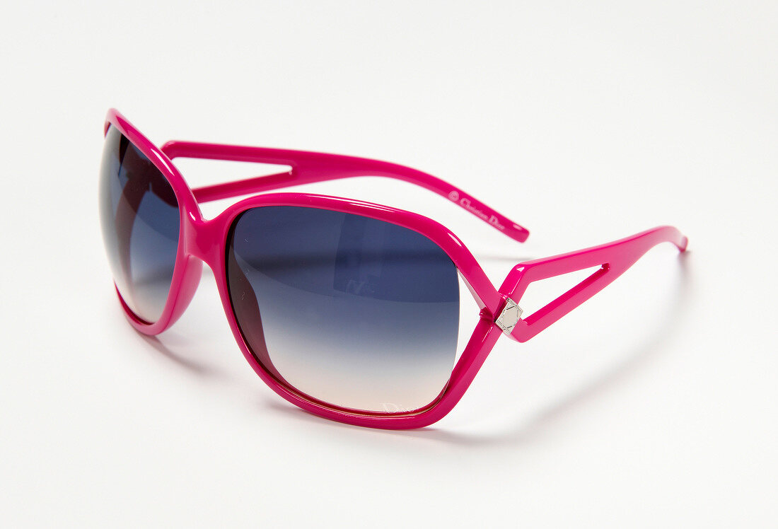 Close-up of pink sunglasses on white background