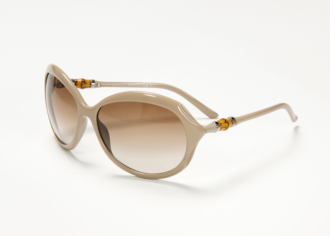 Sunglasses in nude tone on white background