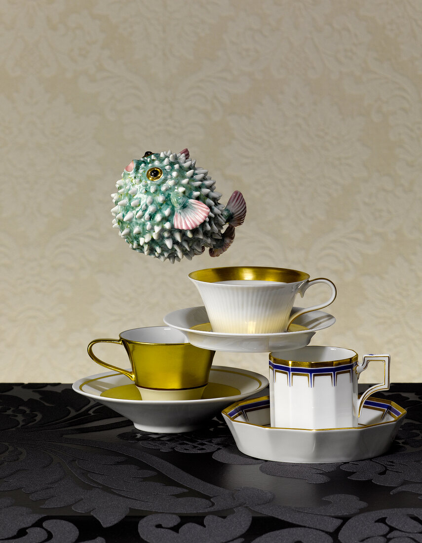 Coffee mugs and porcelain figure of porcupine fish