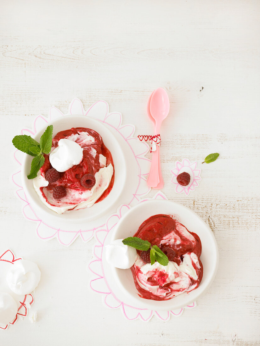 Two dessert with Raspberry sorbet, vanilla curd and meringues in bowl