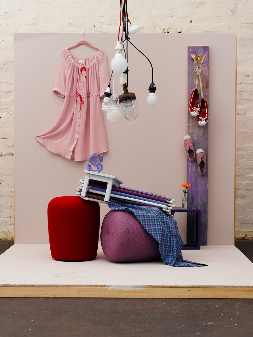 Various clothing and home accessories on pink surface