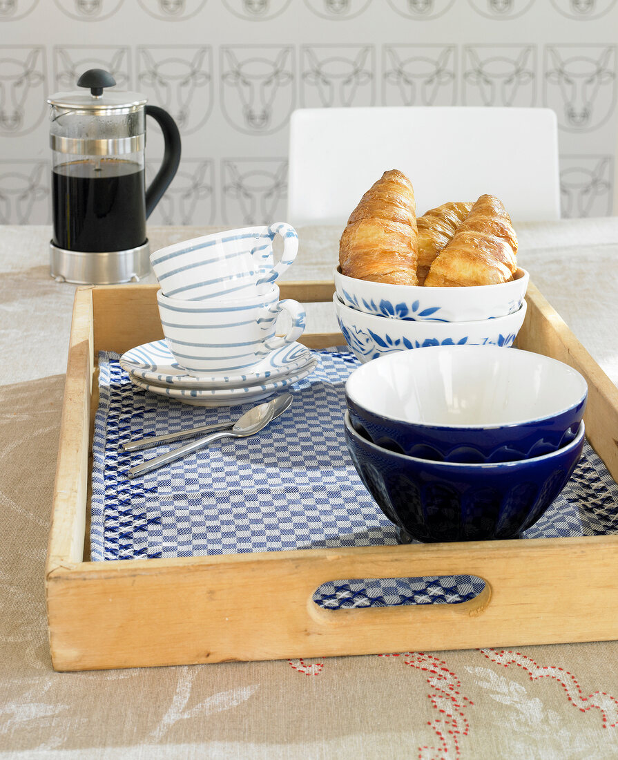 Blue and white croissants with baked bread on breakfast tray