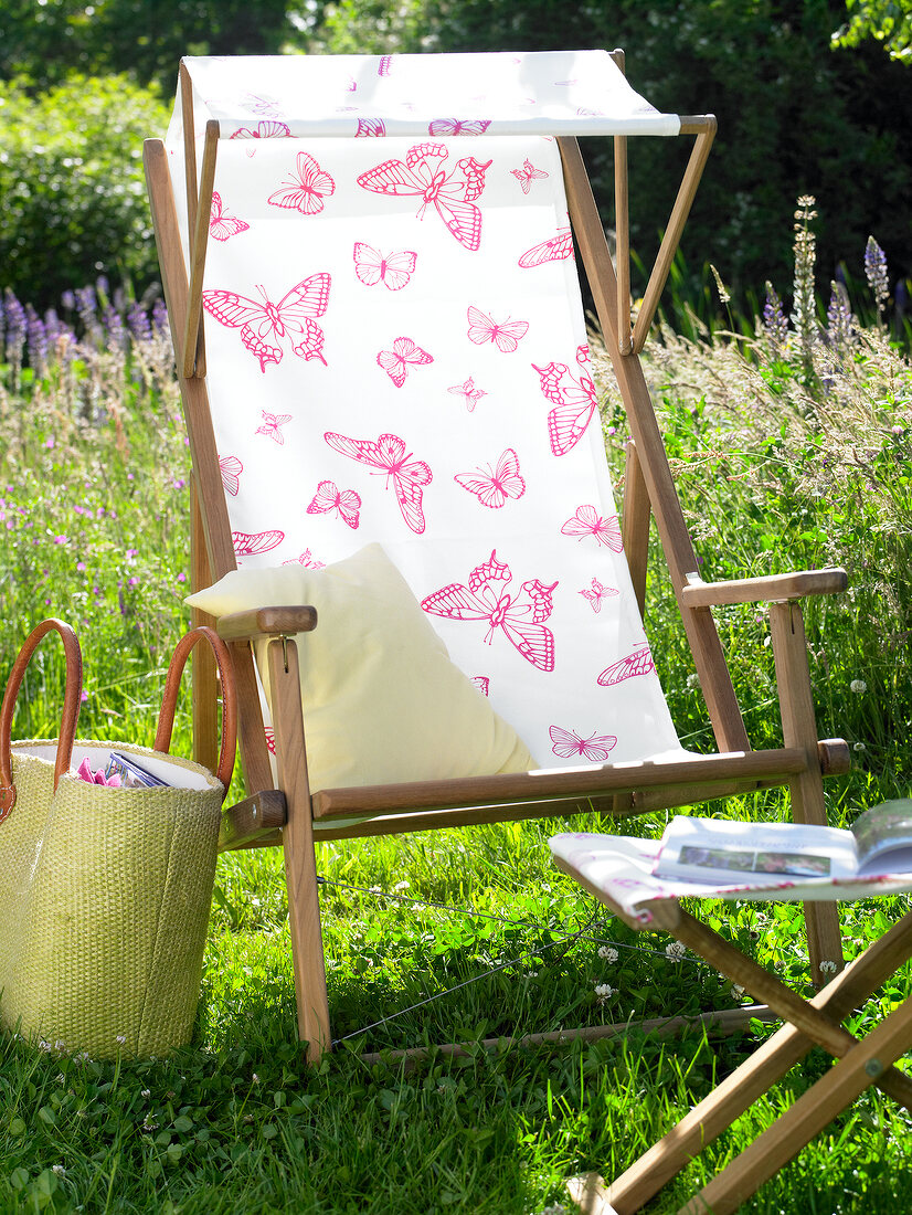 Close-up of deck chair with butterfly pattern and sun canopy
