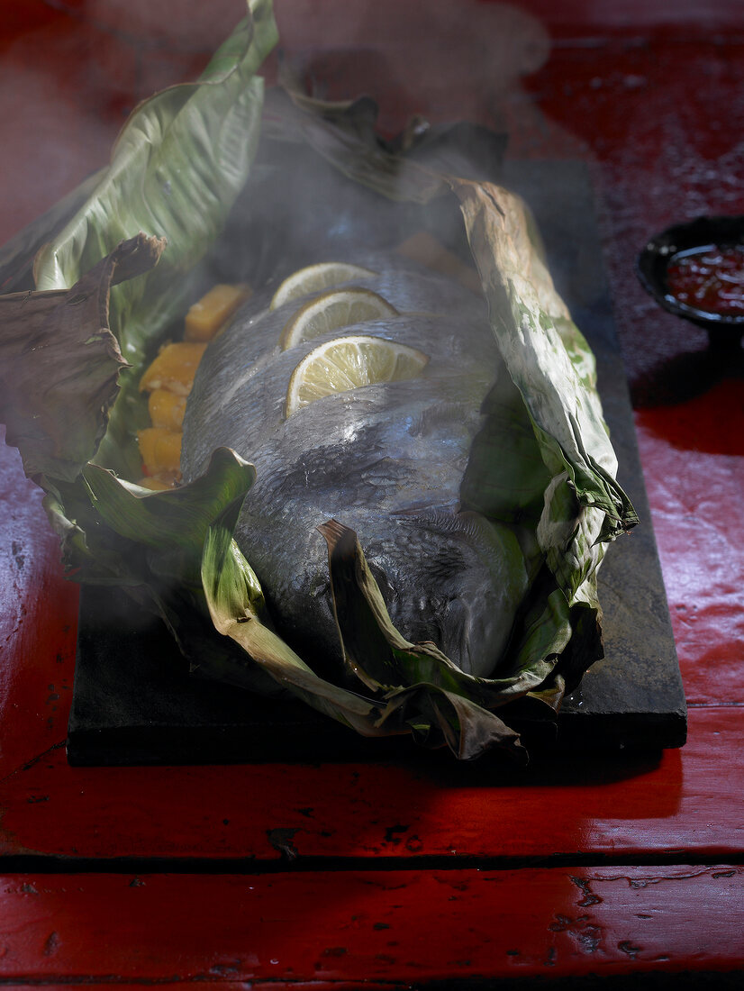 Sea bream and mango steamed in banana leaf