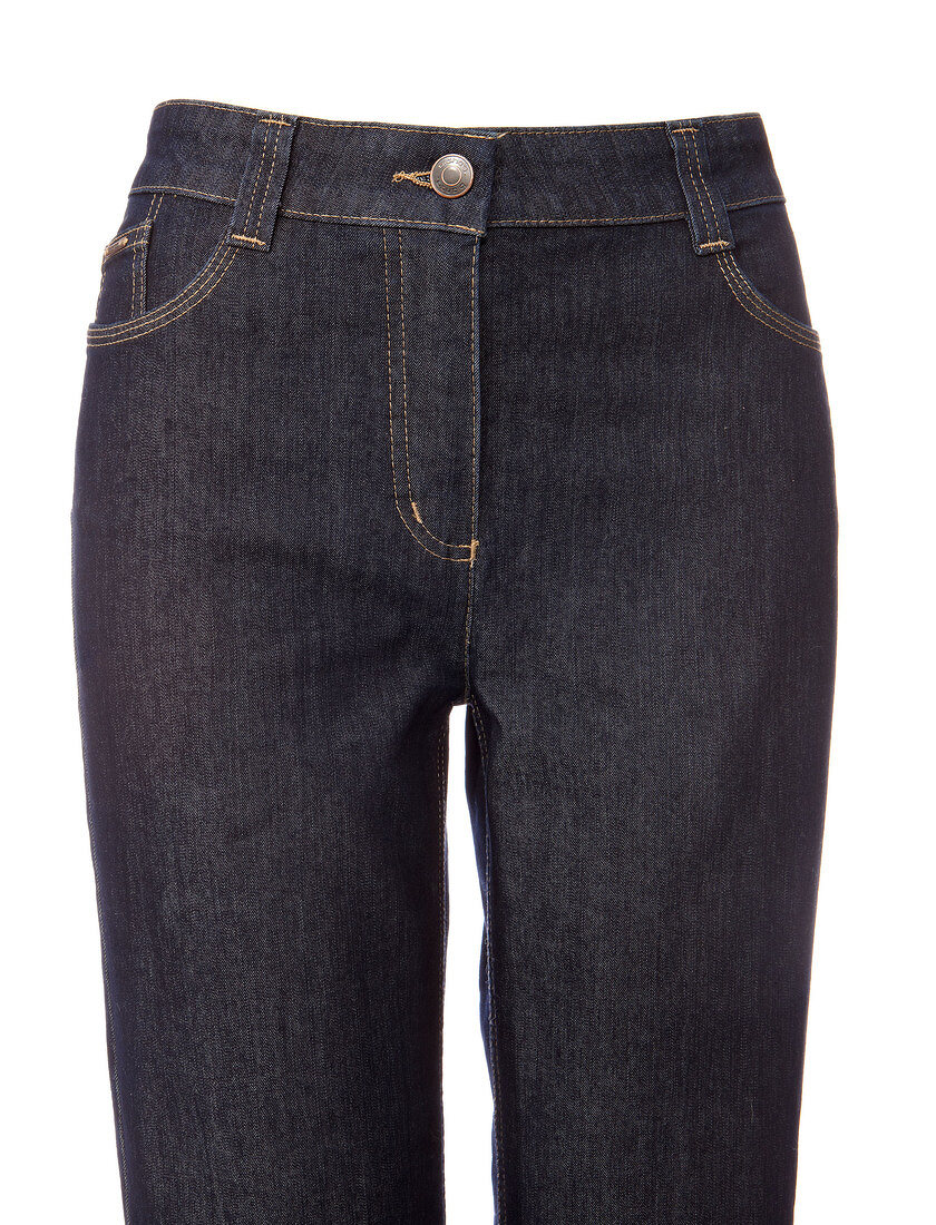Close-up of front view of dark blue jeans on white background