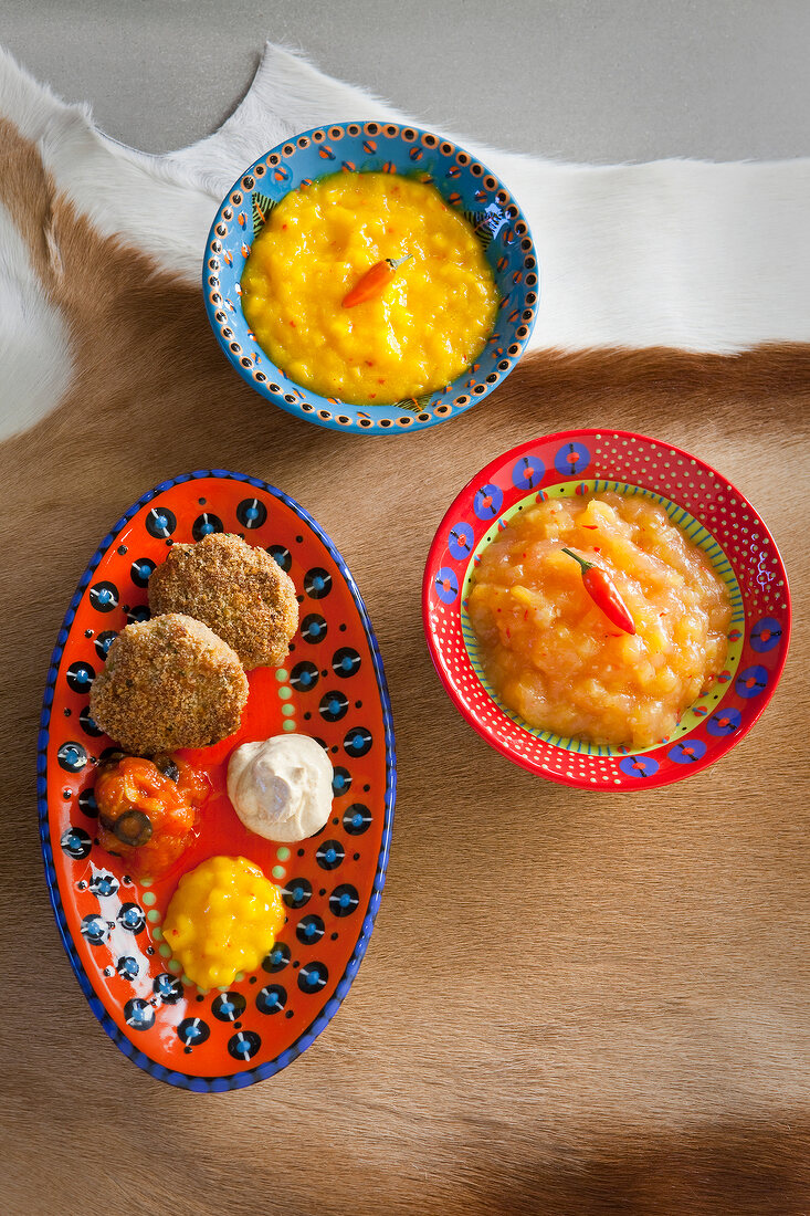 Variety of dips with pineapple, mango, tomato, chili, yogurt and vanilla on tray