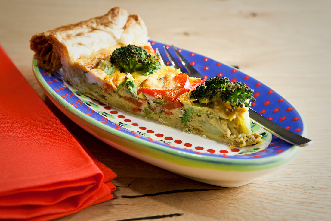 Close-up of coconut curry with piece of chicken tart on tray