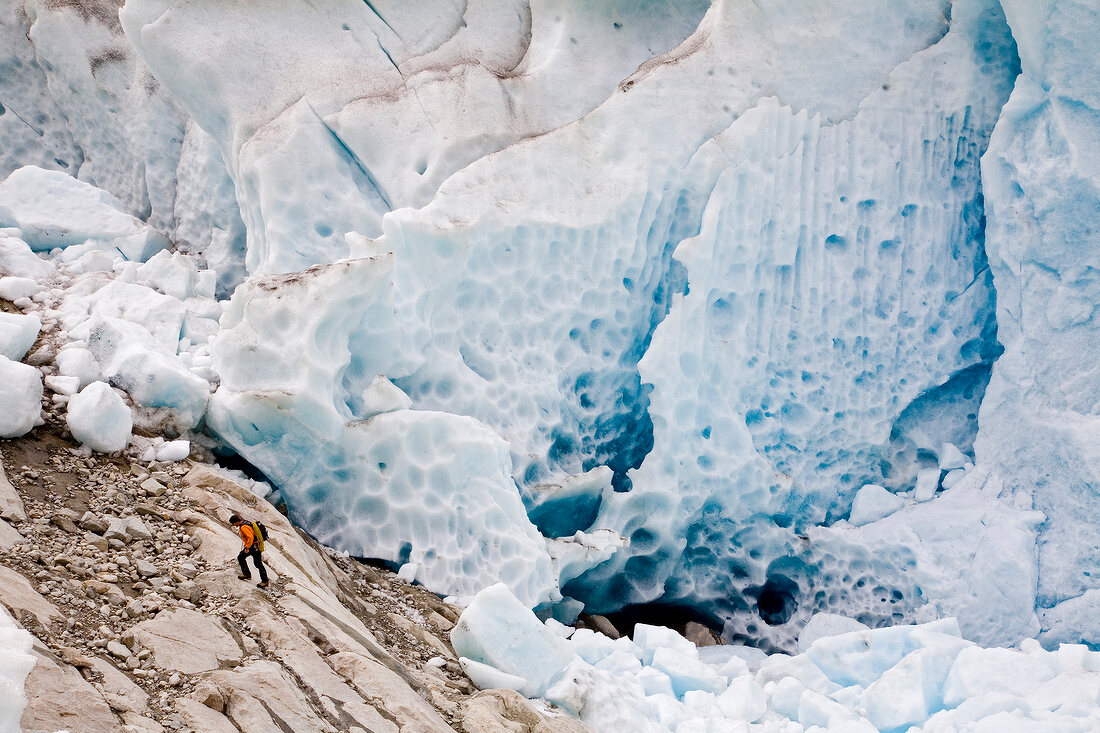 Hiker in front of ice wall in Aletsch Glacier, Marjelesee, Valais, Switzerland