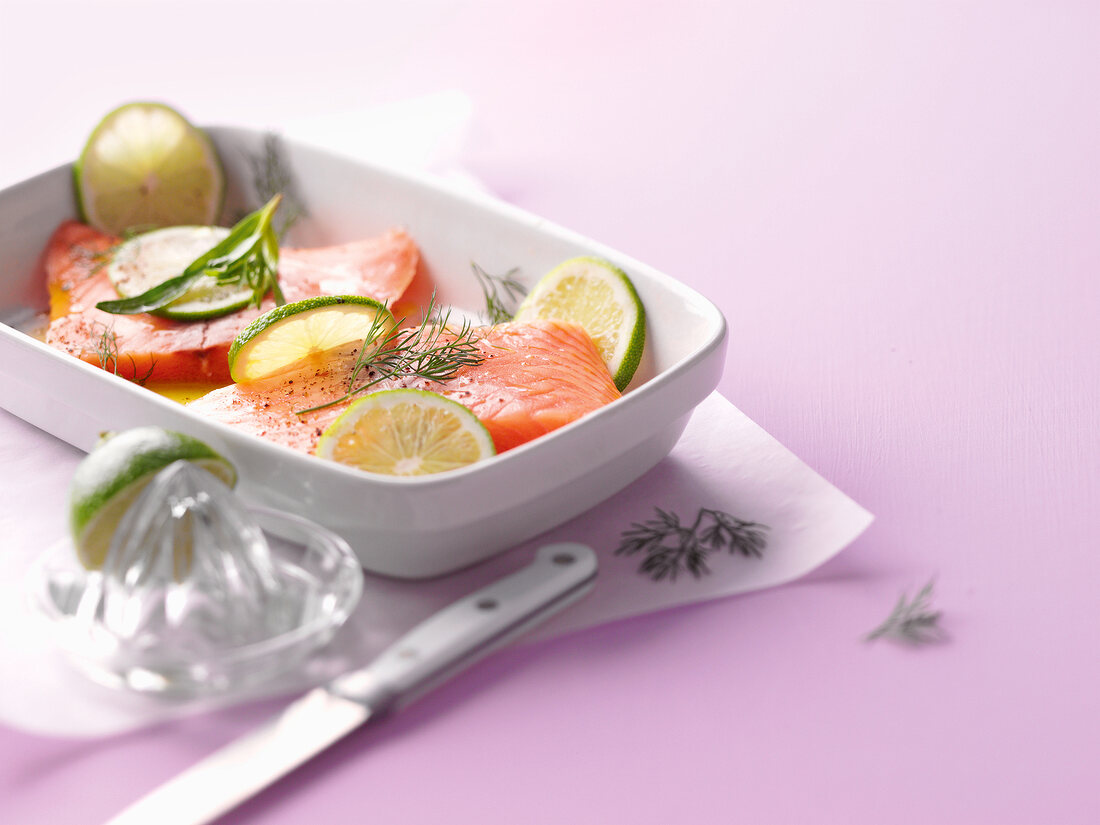 Salmon and lemon slices in baking dish