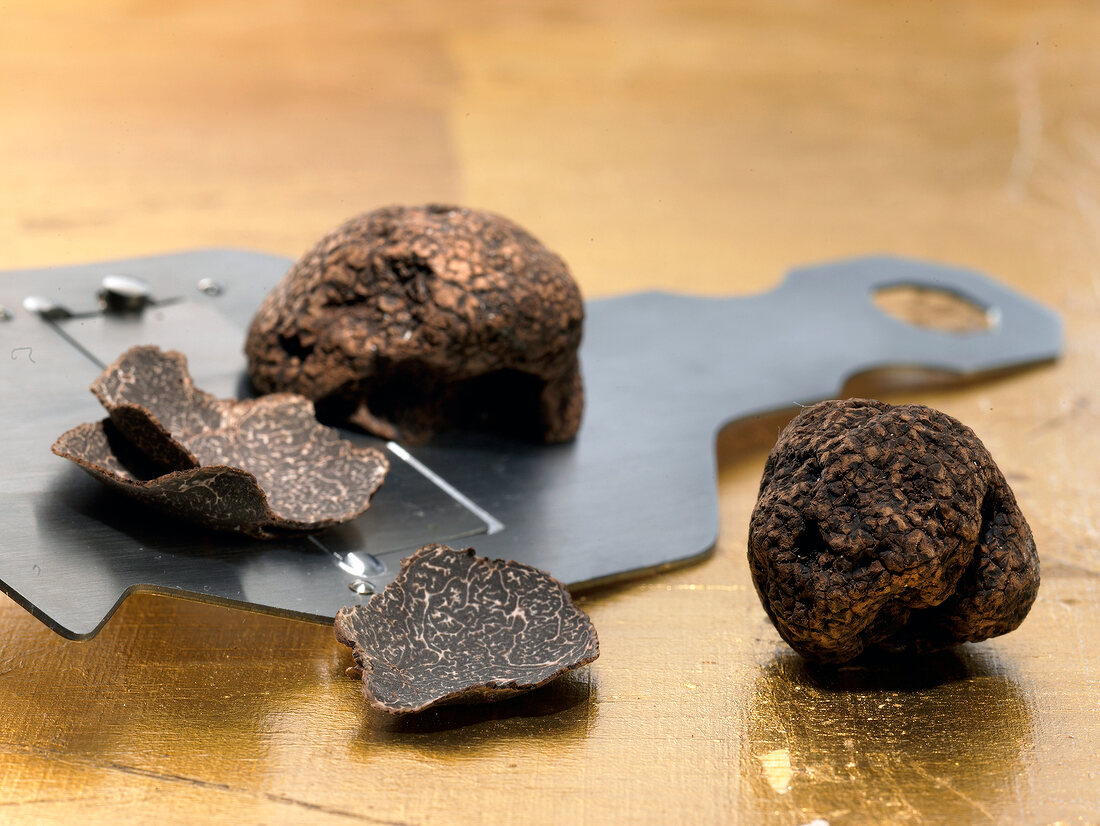Close-up of fresh truffle slices on slicer