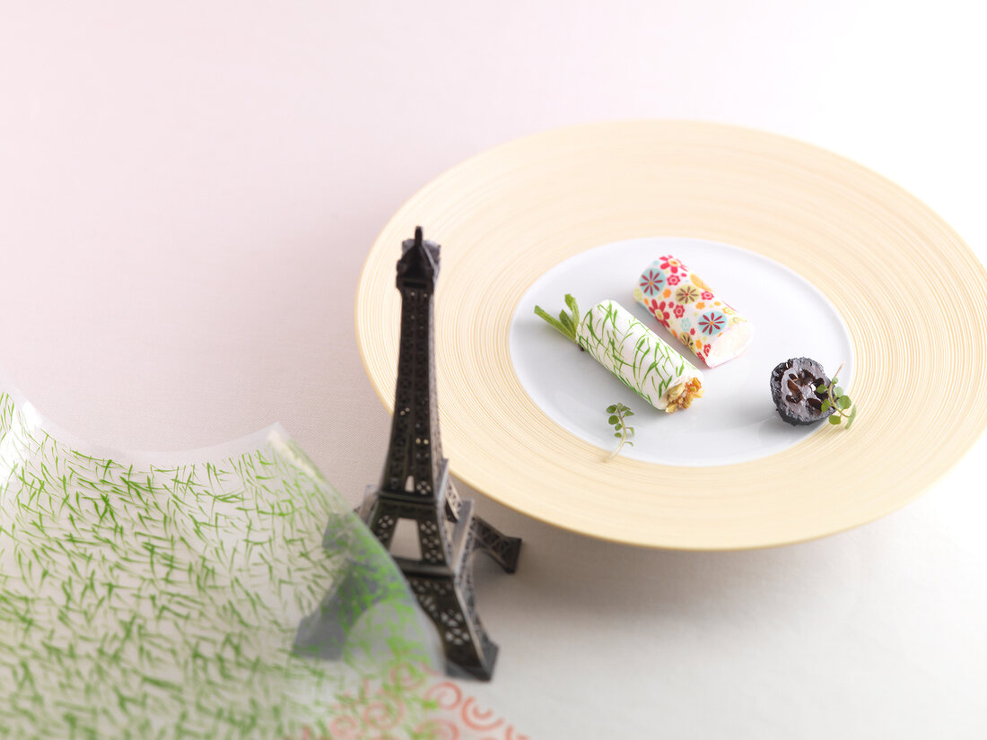 Rolls of glazed vacherin with honey cream on plate